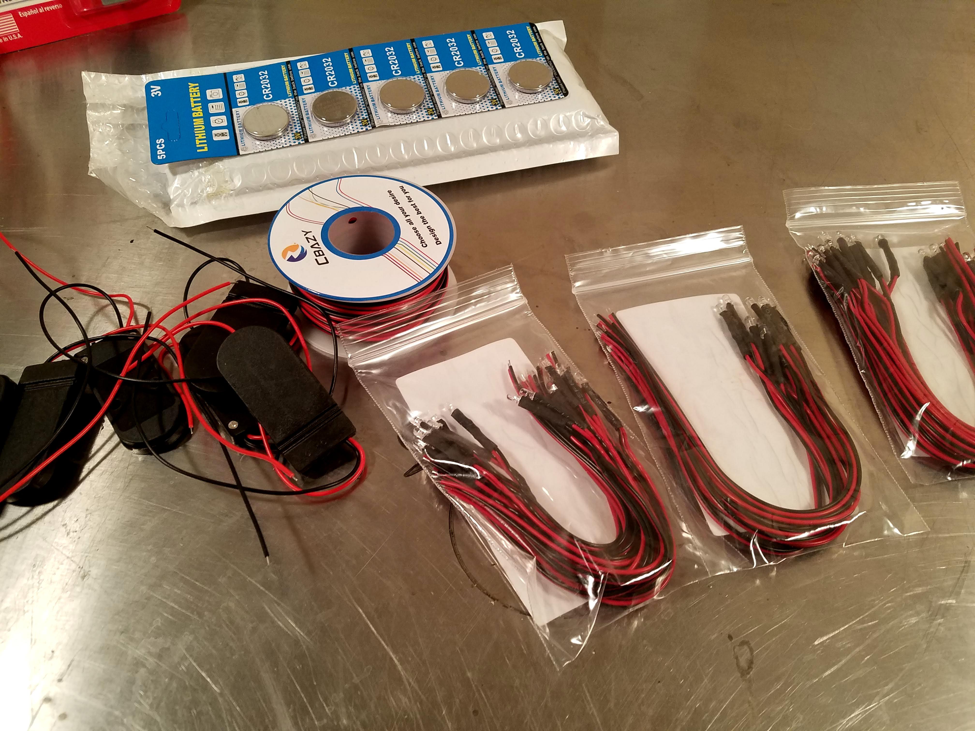 Prewired LEDs in three colors, coin cell batteries, housings, and wire